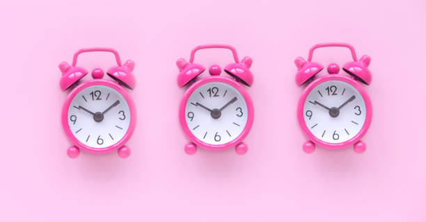 istock Pink alarm clock over a pink background. 1764563255
