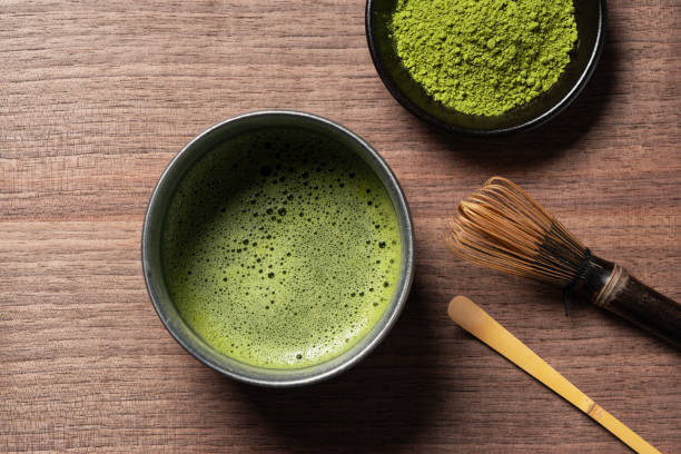 istock Matcha and matcha powder on wooden background. 1764564300