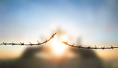 Barbed wire fence with sunset Twilight sky