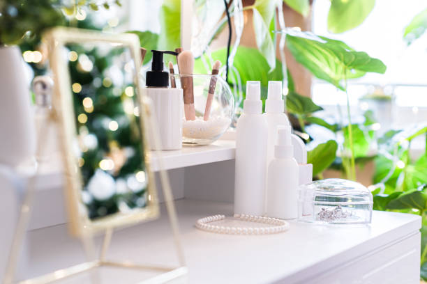 istock Reflection of christmas tree, light bulbs, in table mirror on woman dressing table with make up accessories 1764605207