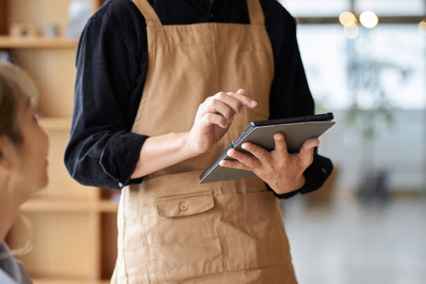 istock Asian male clerk taking orders at a cafe 1764613284