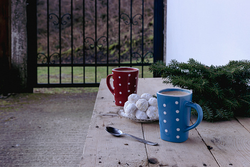 New Year and Christmas composition. National, Christmas greek cookies kourabiedes and a cups of coffee close-up on the table