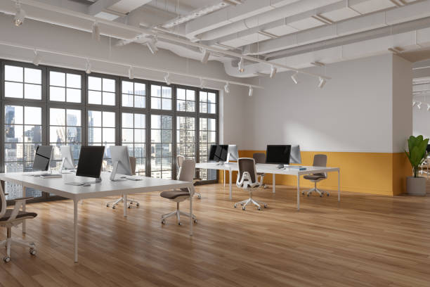 istock Cozy business interior with pc computers and desk with chairs, panoramic window 1764641075