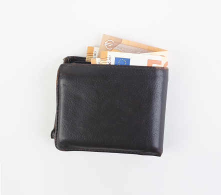 Women's wallet with euro bills on white background.