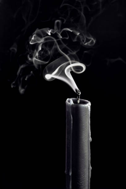 istock Black Candle with white smoke on black background 1764649088