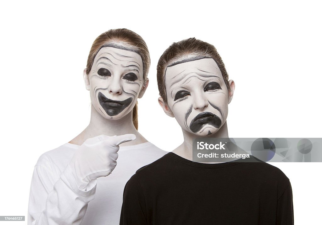 Theatre Masks Two young teenage girls with their faces painted as the Theatre Masks. Comedy Mask Stock Photo