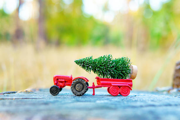 istock Toy Tractor with Miniature Christmas Tree in the Bed 1764653316
