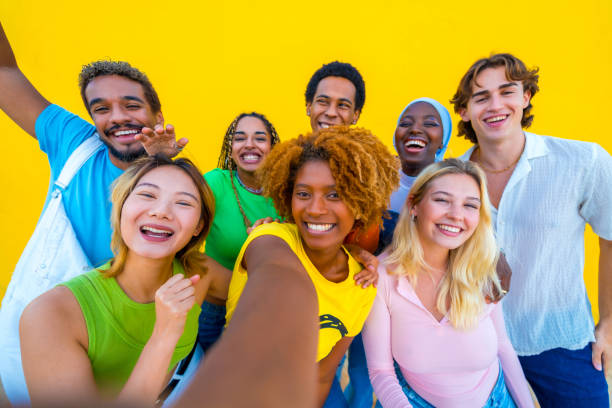istock Young multi-ethnic people taking a selfie in a yellow background 1764657753