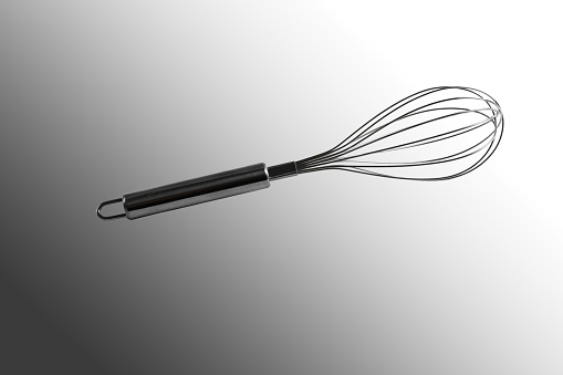 Whisk for whipping. Close-up. Isolated on a gray background.