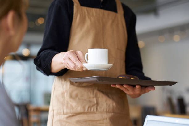Asian male clerk working at a cafe