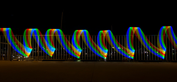 Light painted fence with blue, red, green and yellow