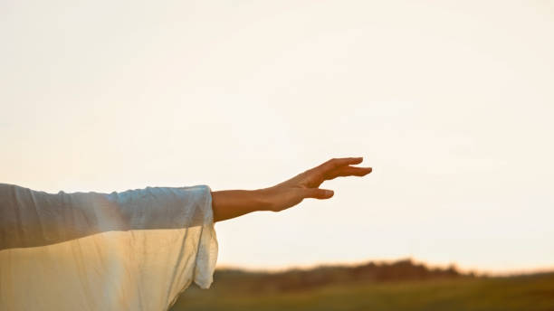 A young girl in light attire expresses joy as she runs with outstretched arms through a lush wheat field, her movement evokes a sense of freedom.