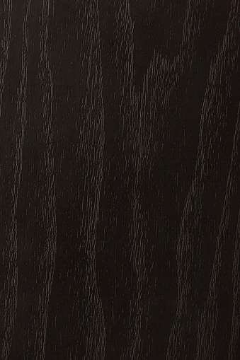 Subtle background of black-painted wood with visible highlighted wood grain.