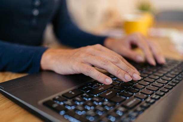 istock Young Woman Working On A Laptop At The Kitchen Table 1764692430