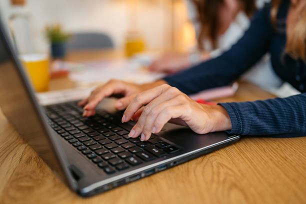 istock Young Woman Working On A Laptop At The Kitchen Table 1764693001