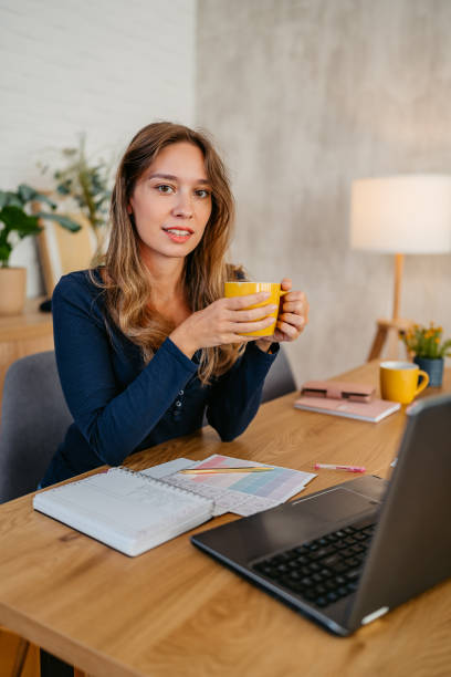istock Young Woman Working On A Laptop At The Kitchen Table 1764693189