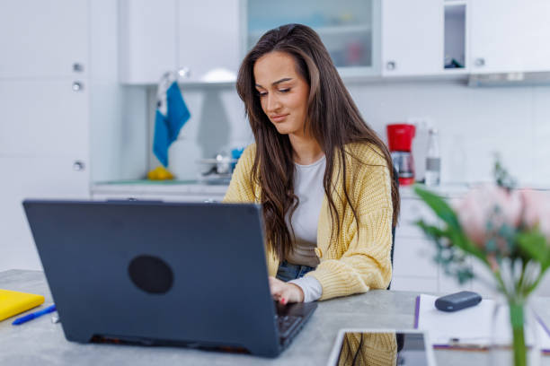istock Young woman finishing up work on her laptop 1764694620