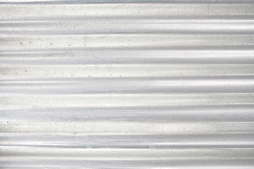 Sheet of corrugated iron, suitable for use as a background or texture in a building or construction context.