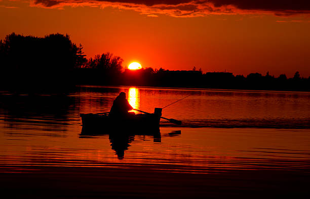 istock beautiful sunset in the lake and boat 176470441