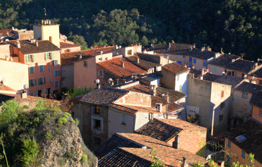 Small medieval village with old beautiful traditional houses on the hills in Provence, France. Sunset light, view from above