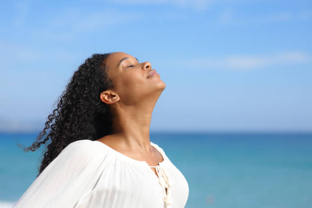 istock Black woman in white breathing in the beach 1764723751