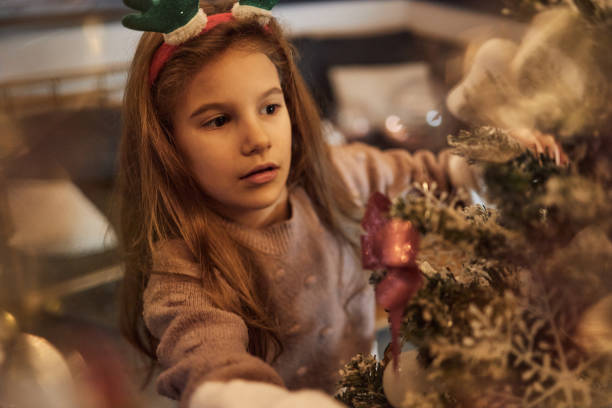 istock Happy girl decorating Christmas Tree 1764726063