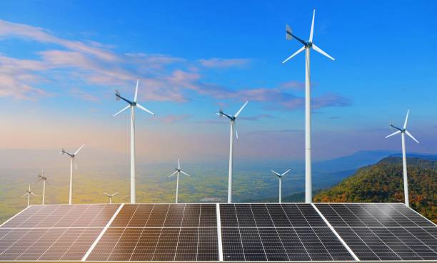 istock Solar panels and wind turbines with mountain landscape 1764729801