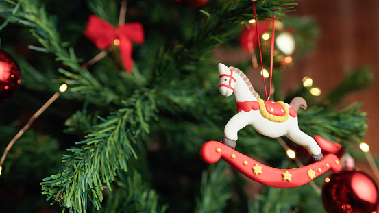 horse decoration hanging from a Christmas tree .