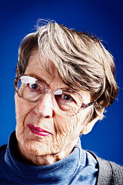 istock Interested old woman listens to something, smiling gently 176474818