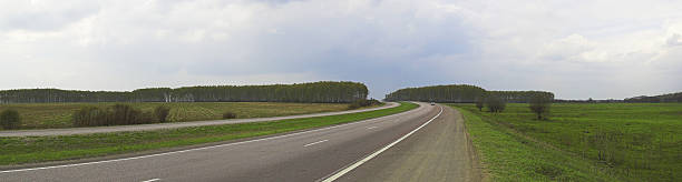 istock High-speed empty highway in a bright sunny day 176474950