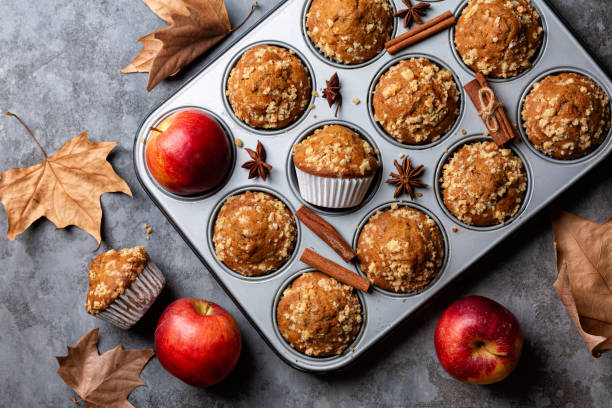 istock Baking tray with just cooked apple cinnamon streusel muffins. Autumn pastry background. Homemade bakery. Grey table surface. 1764760064