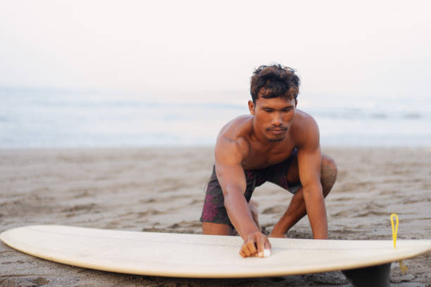 Group of Multicultural Friends Surfing in Canggu Beach Bali