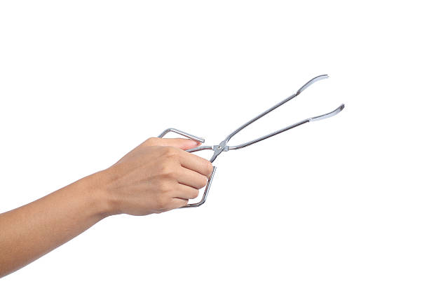istock Woman hand holding an opened kitchen tongs 176477563