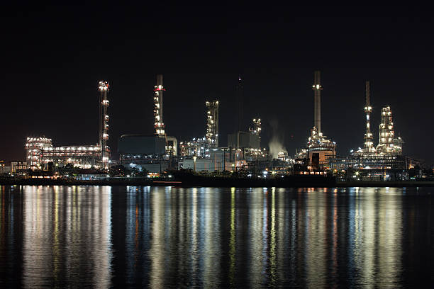 istock Petroleum oil refinery beside the river at night 176477781