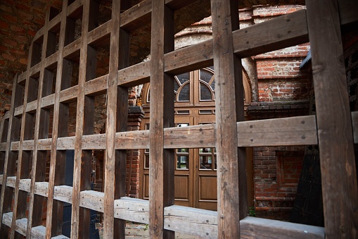 Pattern of wooden post roof, old ruined dark structure. Teriberka