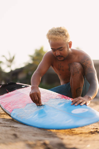 Group of Multicultural Friends Surfing in Canggu Beach Bali