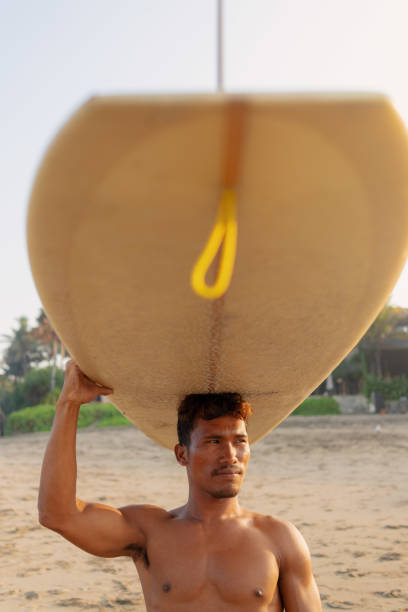 October 15, 2025. Bali, Indonesia. Surfer rides on surfboard at solid wave. Professional surfing in ocean on Impossibles beach