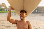 Indonesian Man Surfer Carrying Longboard Surfboard On His Head Morning Sun