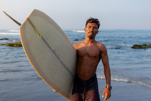 Group of Multicultural Friends Surfing in Canggu Beach Bali