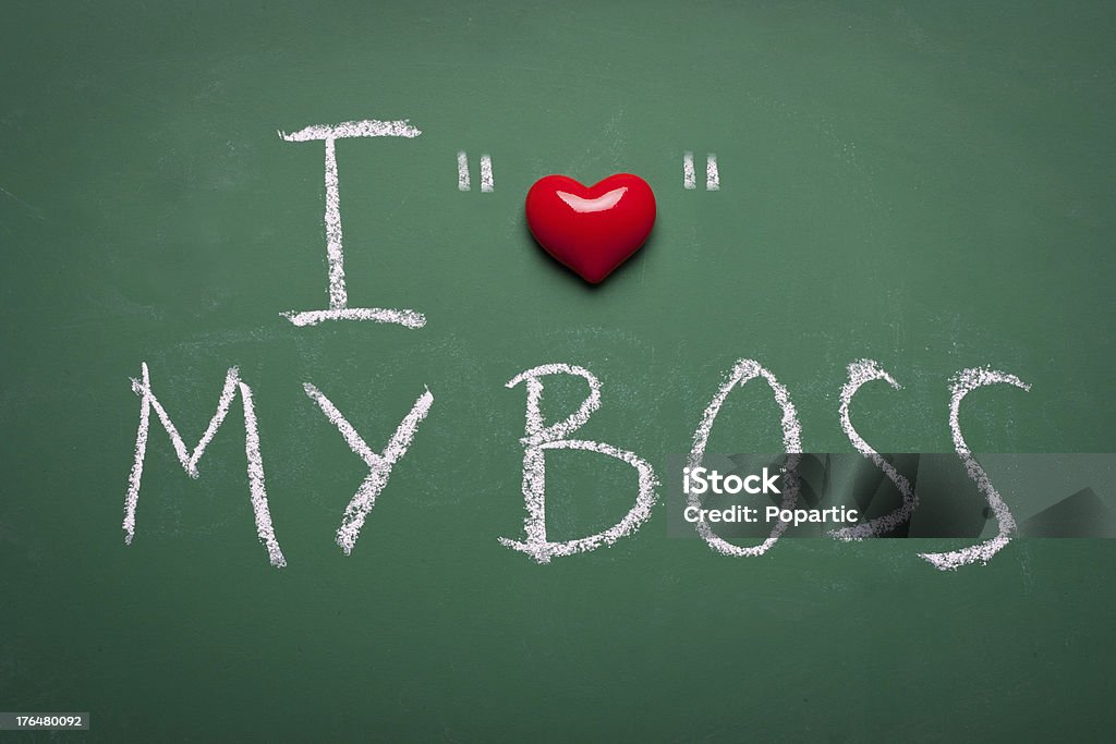 I love my boss, ironic message Ironic message with quotation marks, handwritten on chalkboard. Admiration Stock Photo