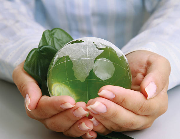 istock attractive woman holding a glass globe 176480233