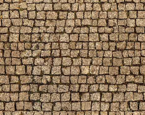 Granite stone pavement seamless texture. Typical roadway in Czechia, grungy background