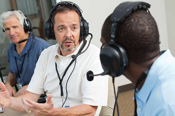 istock Sports commentators and journalists discussing game in press box 176482661