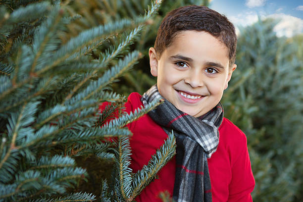 istock Cute Hispanic boy outside at Christmas tree farm 176482687