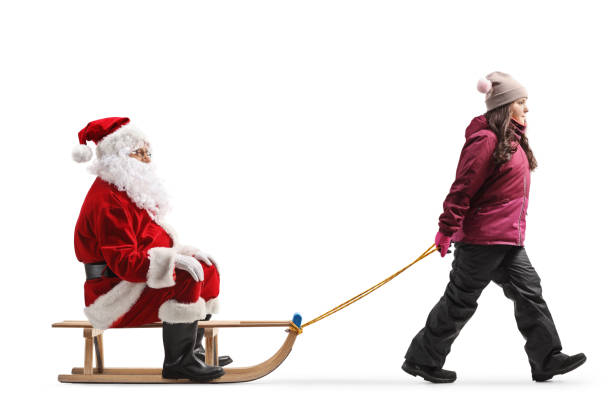 istock Girl in winter clothes pulling a Santa on a sled 1764828590