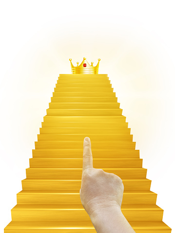 Hand pointing at the golden crown on the golden staircase