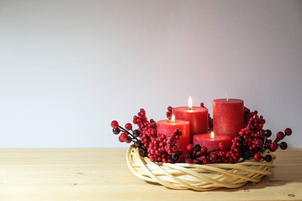 istock Third advent with four red candles, three of them are lighted, arranged in a light willow wicker wreath with artificial berries, holiday decoration, copy space, selected focus 1764854642