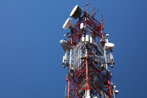 Telecom base station in Poland. Cell tower sector antennas. Mobile 5G transmitter equipment.