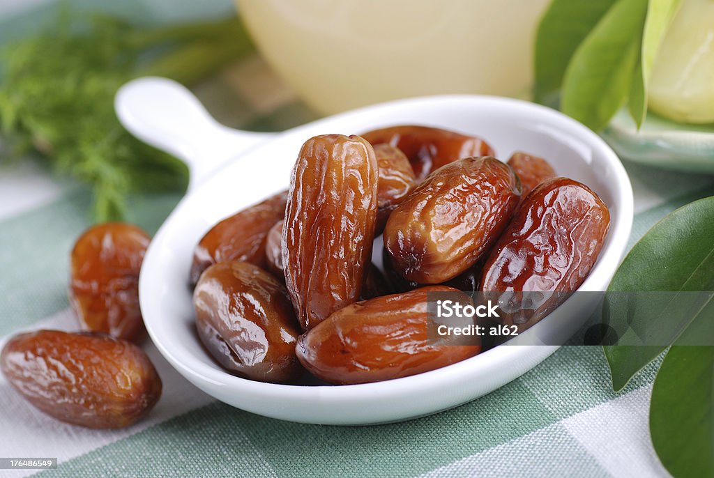 dates on the table dates in small white bowl Brown Stock Photo