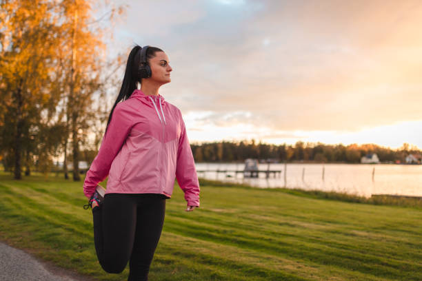 istock Beautiful young woman stretching outdoors during sunset 1764892737
